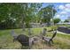Relaxing backyard setting with a cozy fire pit surrounded by comfortable seating and mature trees at 290 Greenwood Cir, Ormond Beach, FL 32174