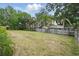Expansive backyard featuring lush green grass, mature trees, and a wooden fence at 290 Greenwood Cir, Ormond Beach, FL 32174