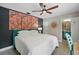Bedroom with custom floral accent wall, ceiling fan, and access to an ensuite bathroom at 290 Greenwood Cir, Ormond Beach, FL 32174