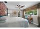 Bedroom featuring a unique floral wall design, wood ceiling fan, and a view into an attached bathroom at 290 Greenwood Cir, Ormond Beach, FL 32174