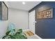Welcoming entryway with a decorative chair, plant, and a custom wall accent at 290 Greenwood Cir, Ormond Beach, FL 32174