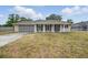 Charming single-story home featuring a unique garage door and well-maintained lawn at 290 Greenwood Cir, Ormond Beach, FL 32174