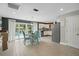 Open-concept kitchen and dining area with sliding glass doors to the pool area at 290 Greenwood Cir, Ormond Beach, FL 32174