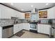 Modern kitchen featuring stainless steel appliances, granite countertops, and ample cabinet space at 290 Greenwood Cir, Ormond Beach, FL 32174