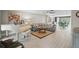 Spacious living room showcasing neutral decor, a grand piano, and adjacent dining area at 290 Greenwood Cir, Ormond Beach, FL 32174