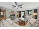 Cozy living room with a large sofa, decorative elements, and a view of the entryway at 290 Greenwood Cir, Ormond Beach, FL 32174