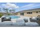 Inviting backyard oasis with a sparkling pool, lounge area, and a neutral colored patio at 290 Greenwood Cir, Ormond Beach, FL 32174