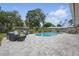 Beautiful backyard with a refreshing pool, charming landscaping, and outdoor seating area at 290 Greenwood Cir, Ormond Beach, FL 32174
