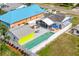Aerial view of fenced in backyard with in ground pool, spa and brightly colored neighboring houses at 342 Euclid Ave, Daytona Beach, FL 32118