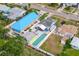 Aerial view of house with long pool, spa and brightly painted neighboring houses at 342 Euclid Ave, Daytona Beach, FL 32118