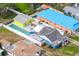 Aerial view of colorful homes, showcasing the backyard pool, hot tub and outdoor lounge area, all enclosed by a white fence at 342 Euclid Ave, Daytona Beach, FL 32118