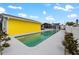 Backyard with a swimming pool, pool house, and white privacy fence, offering a private retreat at 342 Euclid Ave, Daytona Beach, FL 32118