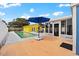Outdoor space featuring a pool, spa, dining area, umbrella, and a bright yellow pool house at 342 Euclid Ave, Daytona Beach, FL 32118