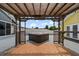 Backyard hot tub under a pergola with a bar in a yard that has a pool and nearby homes at 342 Euclid Ave, Daytona Beach, FL 32118