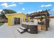 Hot tub with wooden pergola and the home's french doors provide access to the kitchen area at 342 Euclid Ave, Daytona Beach, FL 32118