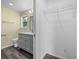 Bathroom featuring modern vanity with dual sinks and an adjacent closet at 342 Euclid Ave, Daytona Beach, FL 32118