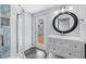 Bright bathroom features a shower, vanity with white drawers and an outdoor exit door at 342 Euclid Ave, Daytona Beach, FL 32118
