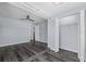 Spacious bedroom with dark floors, ceiling fan, and closet at 342 Euclid Ave, Daytona Beach, FL 32118