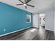 Bedroom featuring dark wood floors, barn style door to bathroom and a ceiling fan at 342 Euclid Ave, Daytona Beach, FL 32118