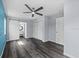 Bedroom featuring gray walls, barn-style door to bathroom and ceiling fan at 342 Euclid Ave, Daytona Beach, FL 32118