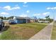Home with well manicured green lawn, blue paint, and a front facing garage at 342 Euclid Ave, Daytona Beach, FL 32118