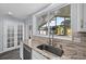 Well-lit kitchen with stainless appliances and stone countertops overlooking the yard at 342 Euclid Ave, Daytona Beach, FL 32118