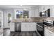 Updated kitchen featuring stainless appliances, stone backsplash, and wood-look floors at 342 Euclid Ave, Daytona Beach, FL 32118