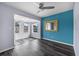 Inviting living room featuring dark wood flooring, a ceiling fan, and ample natural light from multiple windows at 342 Euclid Ave, Daytona Beach, FL 32118