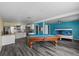 Spacious living room featuring a pool table, bunk beds and updated kitchen at 342 Euclid Ave, Daytona Beach, FL 32118