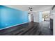 Open living room featuring wood-look floors and bright blue accent wall at 342 Euclid Ave, Daytona Beach, FL 32118