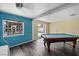 Large living room area with a pool table and view of the backyard pool at 342 Euclid Ave, Daytona Beach, FL 32118