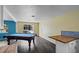 Open living area featuring a pool table and kitchen bar with a view to an outdoor patio at 342 Euclid Ave, Daytona Beach, FL 32118