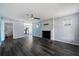 Open living room features dark wood floors, fireplace, and entrance to the kitchen at 342 Euclid Ave, Daytona Beach, FL 32118
