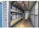 Interior of shed boasts metal framework, built-in shelving, and a white storage cabinet at 342 Euclid Ave, Daytona Beach, FL 32118