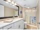 Updated bathroom features a glass shower door and decorative seashell decor at 3743 S Atlantic Ave # 11D, Daytona Beach Shores, FL 32118