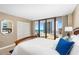 Bright bedroom boasts ocean view and sliding glass doors to balcony at 3743 S Atlantic Ave # 11D, Daytona Beach Shores, FL 32118
