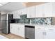 Modern kitchen featuring custom backsplash and stainless steel appliances at 3743 S Atlantic Ave # 11D, Daytona Beach Shores, FL 32118