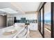 Bright kitchen with white cabinetry, breakfast bar, and stainless appliances at 3743 S Atlantic Ave # 11D, Daytona Beach Shores, FL 32118