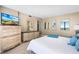 Bright main bedroom with dresser, mirror, and large windows to see ocean view at 3743 S Atlantic Ave # 11D, Daytona Beach Shores, FL 32118