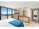 Bright main bedroom features large windows, beautiful views, a stylish decor and ensuite bathroom at 3743 S Atlantic Ave # 11D, Daytona Beach Shores, FL 32118