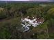 Aerial view of the property with palm trees, a pool, and lush greenery at 37918 N County Road 44A, Eustis, FL 32736