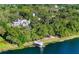 Aerial view of a lakefront property featuring a large home, boat dock, and lush greenery at 37918 N County Road 44A, Eustis, FL 32736