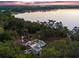 Aerial view featuring a home, a pool, a lake, and lush surrounding landscape at 37918 N County Road 44A, Eustis, FL 32736