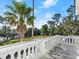 Balcony view features tropical landscaping, blue sky, and a bright sunny day at 37918 N County Road 44A, Eustis, FL 32736