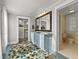 Bright bathroom featuring colorful tile flooring, dual vanities, and access to a closet at 37918 N County Road 44A, Eustis, FL 32736