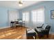 Charming bedroom with light blue walls, hardwood floors, and two bright windows at 37918 N County Road 44A, Eustis, FL 32736