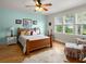 Light bedroom with hardwood floors, a ceiling fan, and natural light, creating a relaxing atmosphere at 37918 N County Road 44A, Eustis, FL 32736