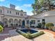 Charming courtyard featuring a fountain, arched walkways, and lush greenery at 37918 N County Road 44A, Eustis, FL 32736