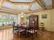 Elegant dining room with coffered ceilings, decorative walls, hardwood floors, and large windows at 37918 N County Road 44A, Eustis, FL 32736
