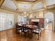 Elegant dining room featuring a brick fireplace, hardwood floors, chandelier, and access to other rooms at 37918 N County Road 44A, Eustis, FL 32736